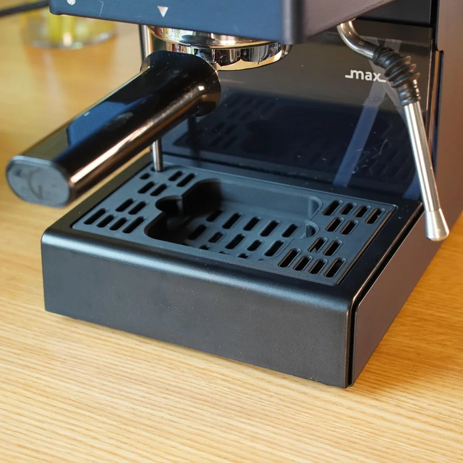 A black 3D-printed drip tray cover on a Gaggia Classic, with a small BOOKOO Themis Mini scale sitting in a recess under the group head